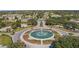 Aerial view of a community entrance with a water fountain and lush landscaping at 8660 Se 132Nd Ln, Summerfield, FL 34491