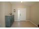 Inviting entryway featuring neutral tile flooring, a decorative cabinet, and a bright front door with sidelight at 8660 Se 132Nd Ln, Summerfield, FL 34491