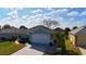 A lovely single-story home with a two-car garage, well-kept landscaping, and a spacious driveway at 8660 Se 132Nd Ln, Summerfield, FL 34491