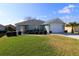 Charming home with a well-manicured lawn, lush landscaping, and a two-car garage at 8660 Se 132Nd Ln, Summerfield, FL 34491