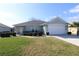 Charming one-story home featuring a well-maintained lawn, tidy landscaping, and a two-car garage at 8660 Se 132Nd Ln, Summerfield, FL 34491