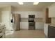 Well-lit kitchen featuring stainless steel appliances, ample cabinet space, and a neutral color palette at 8660 Se 132Nd Ln, Summerfield, FL 34491