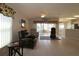 Bright living room with sliding glass doors leading to a lanai and an open view into the kitchen at 8660 Se 132Nd Ln, Summerfield, FL 34491