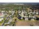 Aerial view of homes in a neighborhood adjacent to vast green spaces at 887 Daisy Hill Ct, Apopka, FL 32712