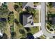 Aerial view of a home featuring a dark roof, long driveway, and green trees at 887 Daisy Hill Ct, Apopka, FL 32712