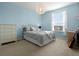 Bedroom featuring a large bed with gray comforter, a ceiling fan, and carpeted floors at 887 Daisy Hill Ct, Apopka, FL 32712