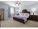 Bedroom featuring a plush bed with mauve comforter, a ceiling fan, and carpeted floors at 887 Daisy Hill Ct, Apopka, FL 32712