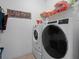 Functional laundry room featuring modern washer and dryer, and ample space for storage at 887 Daisy Hill Ct, Apopka, FL 32712