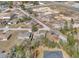 Overhead view of a neighborhood with single-Gathering homes and an expansive sandy lot nearby at 9150 Se 153Rd Pl, Summerfield, FL 34491