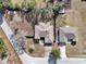 Aerial view of the property showing its roofline, driveway, and landscaped surroundings at 9150 Se 153Rd Pl, Summerfield, FL 34491