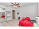 Versatile bedroom featuring tile floors, natural light, a ceiling fan, and ample storage space at 9150 Se 153Rd Pl, Summerfield, FL 34491