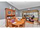 Cozy dining room with hardwood table and chairs, decorative hutch, and ample natural light at 9150 Se 153Rd Pl, Summerfield, FL 34491