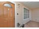 Charming front entrance with a decorative door, a window, and a classic exterior light fixture at 9150 Se 153Rd Pl, Summerfield, FL 34491