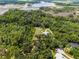 Overhead shot of a house in a secluded, wooded area with a well-maintained lawn, blending comfort with nature's beauty at 9905 Skylark Ln, Groveland, FL 34736