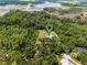 Overhead shot of a house in a secluded, wooded area marked with a pin, blending comfort with nature's beauty at 9905 Skylark Ln, Groveland, FL 34736