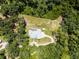 Overhead aerial view of a private home and grounds with lush surrounding trees, providing a sense of seclusion and natural beauty at 9905 Skylark Ln, Groveland, FL 34736