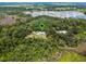 Scenic aerial view of a secluded residence next to a body of water, indicated with a pin blending comfort with nature's beauty at 9905 Skylark Ln, Groveland, FL 34736