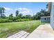 Wide expanse of backyard lawn with a storage shed at 9905 Skylark Ln, Groveland, FL 34736