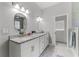 Bathroom with double vanity sink, granite countertop, and decorative lighting at 9905 Skylark Ln, Groveland, FL 34736