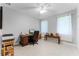 Bedroom with a dark wood desk, desk chair, wooden bench, and tile floors at 9905 Skylark Ln, Groveland, FL 34736