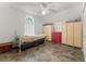 Bedroom with white iron bed, tiled floor and woven partition at 9905 Skylark Ln, Groveland, FL 34736