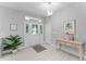 Bright foyer with neutral tones, decorative door, stylish lighting, and console table at 9905 Skylark Ln, Groveland, FL 34736