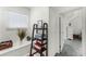 Bright hallway featuring a decorative ladder shelf, window, and door leading to an adjacent room at 9905 Skylark Ln, Groveland, FL 34736