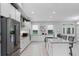 Modern eat-in kitchen featuring white cabinets, granite countertops, stainless appliances and large island with counter seating at 9905 Skylark Ln, Groveland, FL 34736