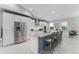 Spacious kitchen featuring stainless steel appliances, a large center island with bar seating, and modern white cabinetry at 9905 Skylark Ln, Groveland, FL 34736