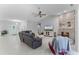 Inviting living room with stone fireplace, vaulted ceilings, and modern tile flooring at 9905 Skylark Ln, Groveland, FL 34736