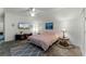 Spacious main bedroom with a ceiling fan, stylish decor, and tiled flooring at 9905 Skylark Ln, Groveland, FL 34736