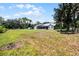 View of the home's backyard and surrounding property, featuring a large green lawn at 9905 Skylark Ln, Groveland, FL 34736