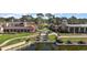 An aerial view of a lakeside resort featuring lush landscaping and unique architecture at 9930 Santa Barbara Ct, Howey In The Hills, FL 34737