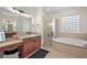 Bathroom featuring a jacuzzi tub, glass-enclosed shower, vanity sinks and a makeup area at 9930 Santa Barbara Ct, Howey In The Hills, FL 34737