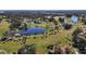 Aerial view of meticulously maintained golf course featuring lakes and palm tree lined fairways at 9930 Santa Barbara Ct, Howey In The Hills, FL 34737