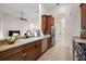 Kitchen view features ample counter space, stainless steel appliances, and wood cabinets at 9930 Santa Barbara Ct, Howey In The Hills, FL 34737