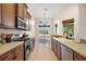 Bright eat-in kitchen featuring stainless steel appliances, modern lighting, and an outdoor view at 9930 Santa Barbara Ct, Howey In The Hills, FL 34737