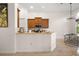 View of the kitchen featuring wood cabinets, stainless microwave and appliances, and breakfast bar at 9930 Santa Barbara Ct, Howey In The Hills, FL 34737