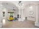 Bright living room featuring soaring ceilings, tile flooring, columns, and a modern light fixture at 9930 Santa Barbara Ct, Howey In The Hills, FL 34737