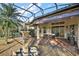 Covered patio with stone fountain and plenty of room for outdoor dining and lounging at 9930 Santa Barbara Ct, Howey In The Hills, FL 34737