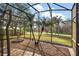 Enclosed outdoor space featuring palm trees, decorative fountain, and brick pavers, perfect for relaxation and entertainment at 9930 Santa Barbara Ct, Howey In The Hills, FL 34737