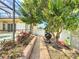 Inviting backyard featuring a paver walkway, lush foliage, and a glimpse of a serene patio at 100 Grand Reserve Dr, Davenport, FL 33837