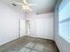 Bedroom featuring neutral walls, carpeted floors, a ceiling fan and closet doors at 100 Grand Reserve Dr, Davenport, FL 33837