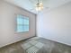 Bedroom with carpeted floor, ceiling fan and natural light streaming through window at 100 Grand Reserve Dr, Davenport, FL 33837