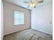 This bedroom is well lit and includes a ceiling fan and window at 100 Grand Reserve Dr, Davenport, FL 33837