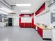 Bright garage with custom red cabinets, epoxy floors, and well-lit workspace for organized storage and projects at 100 Grand Reserve Dr, Davenport, FL 33837