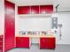 View of a garage with painted red cabinets at 100 Grand Reserve Dr, Davenport, FL 33837