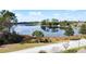 Expansive view of the lake surrounded by mature trees and foliage at 100 Grand Reserve Dr, Davenport, FL 33837