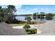 Overhead view of a lake featuring lush landscaping and residential rooftops at 100 Grand Reserve Dr, Davenport, FL 33837