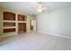 The living room is bathed in natural light, featuring tile floors and built-in shelving on the wall at 100 Grand Reserve Dr, Davenport, FL 33837